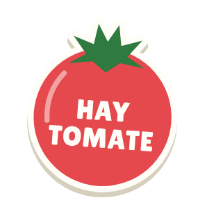 Clac con forma de un tomate y el texto «HAY TOMATE»